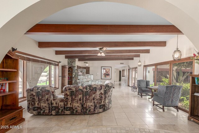 8043 E Laurel St, Mesa, AZ 85207 - living room featuring arched walkways, ceiling fan, tile patterned floors, and beamed ceiling