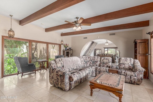 8043 E Laurel St, Mesa, AZ 85207 - living room with a ceiling fan, beam ceiling, arched walkways, and light tile patterned flooring