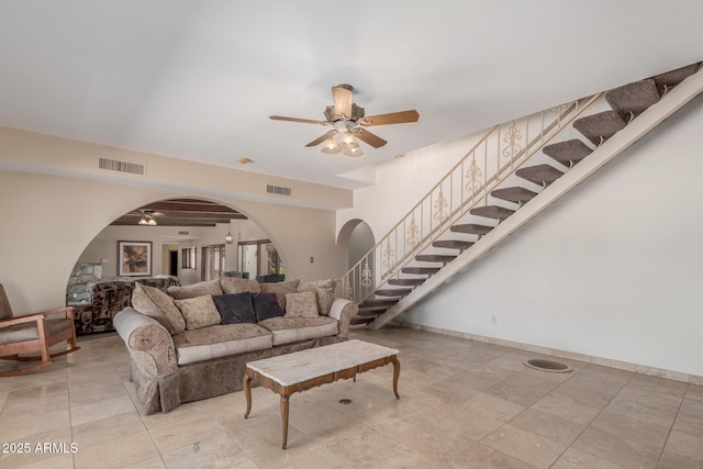 8043 E Laurel St, Mesa, AZ 85207 - living room with a ceiling fan, stairway, and arched walkways