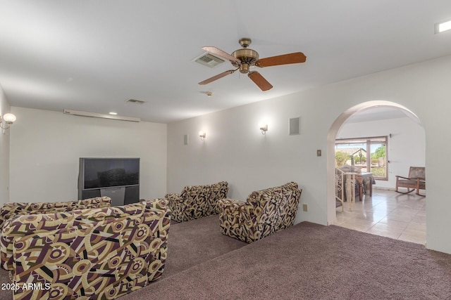 8043 E Laurel St, Mesa, AZ 85207 - carpeted living room featuring arched walkways, ceiling fan, and tile patterned flooring