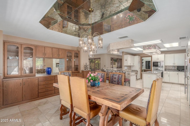 8043 E Laurel St, Mesa, AZ 85207 - dining area with a towering ceiling, a chandelier, and light tile patterned flooring