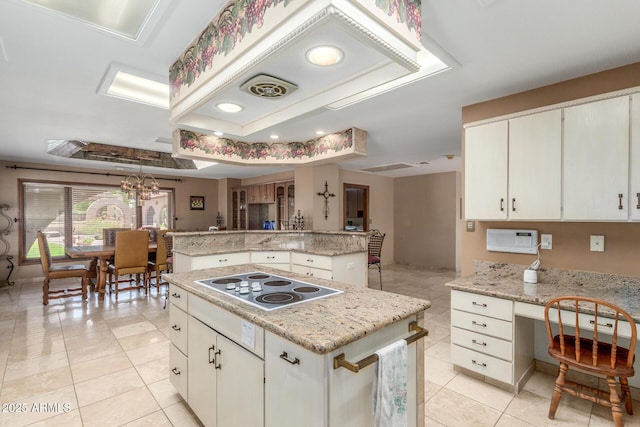 8043 E Laurel St, Mesa, AZ 85207 - kitchen featuring a center island, electric stovetop, a tray ceiling, light tile patterned floors, and a chandelier