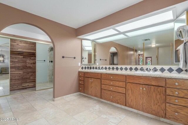 8043 E Laurel St, Mesa, AZ 85207 - bathroom featuring double vanity, backsplash, and walk in shower