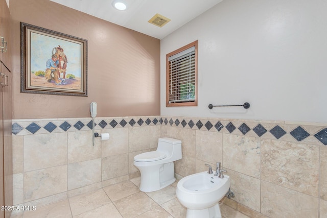 8043 E Laurel St, Mesa, AZ 85207 - bathroom featuring a bidet, tile walls, tile patterned flooring, and a wainscoted wall