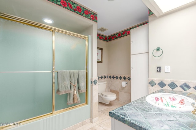 8043 E Laurel St, Mesa, AZ 85207 - bathroom featuring tile patterned floors, tile walls, a wainscoted wall, vanity, and enclosed tub / shower combo