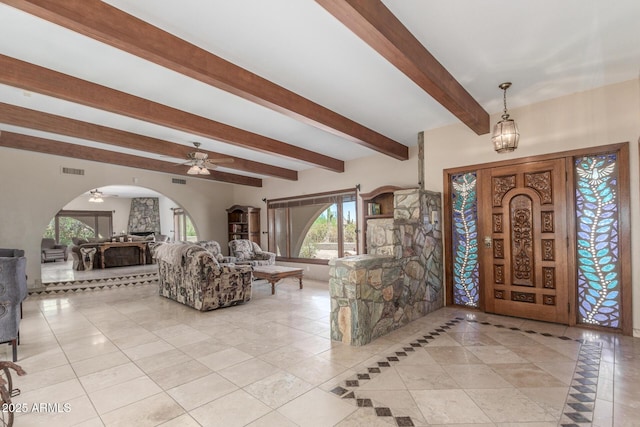 8043 E Laurel St, Mesa, AZ 85207 - foyer entrance with arched walkways, beam ceiling, ceiling fan, and light tile patterned flooring