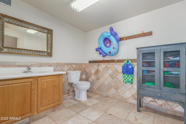 8043 E Laurel St, Mesa, AZ 85207 - bathroom with tile walls, vanity, and a wainscoted wall