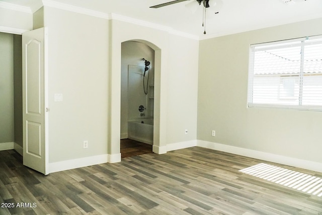 unfurnished bedroom featuring hardwood / wood-style flooring, ornamental molding, ceiling fan, and ensuite bath