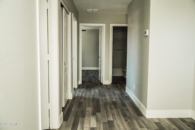 corridor featuring dark hardwood / wood-style flooring