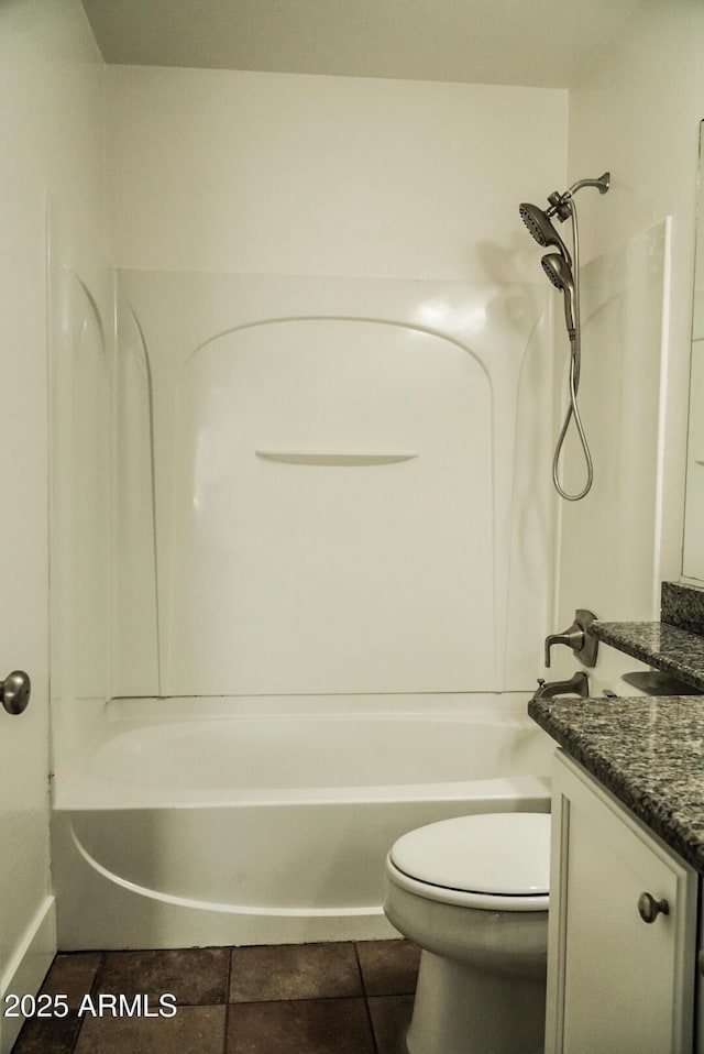 full bathroom with vanity, tile patterned floors, washtub / shower combination, and toilet