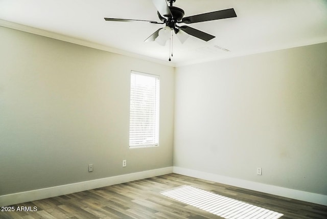 empty room featuring ornamental molding, hardwood / wood-style floors, and ceiling fan