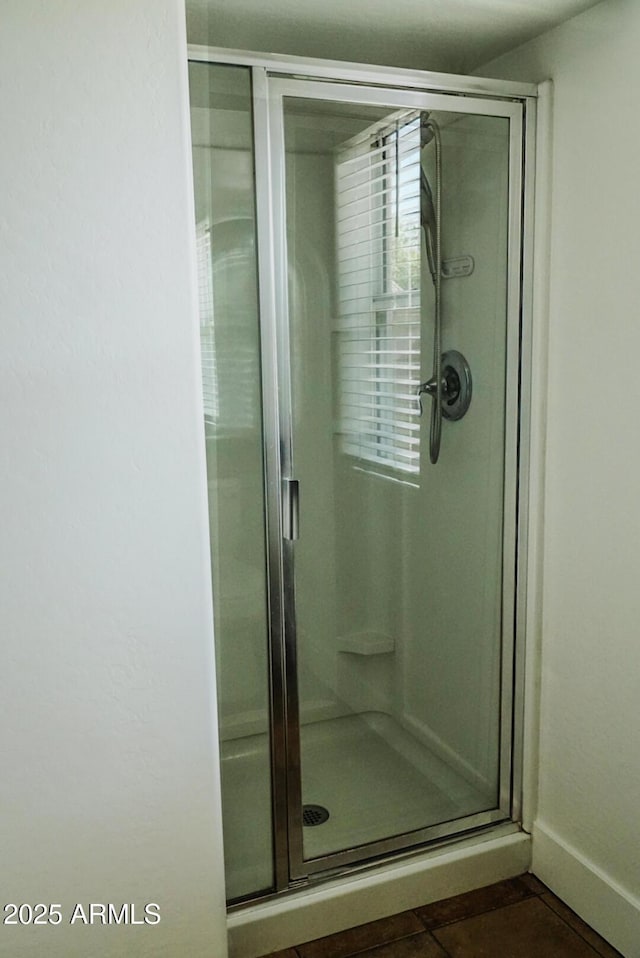 bathroom featuring tile patterned floors and an enclosed shower