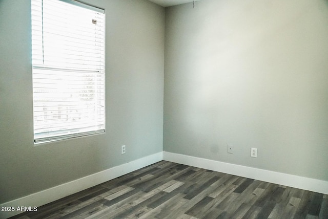 unfurnished room with dark wood-type flooring