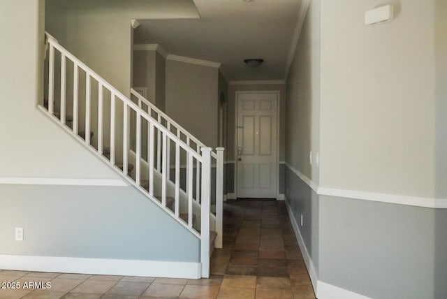 stairway featuring tile patterned flooring and ornamental molding