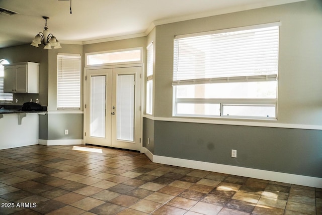 interior space featuring ornamental molding, french doors, and a chandelier