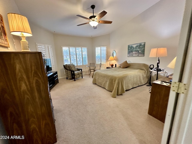 bedroom with ceiling fan and light colored carpet