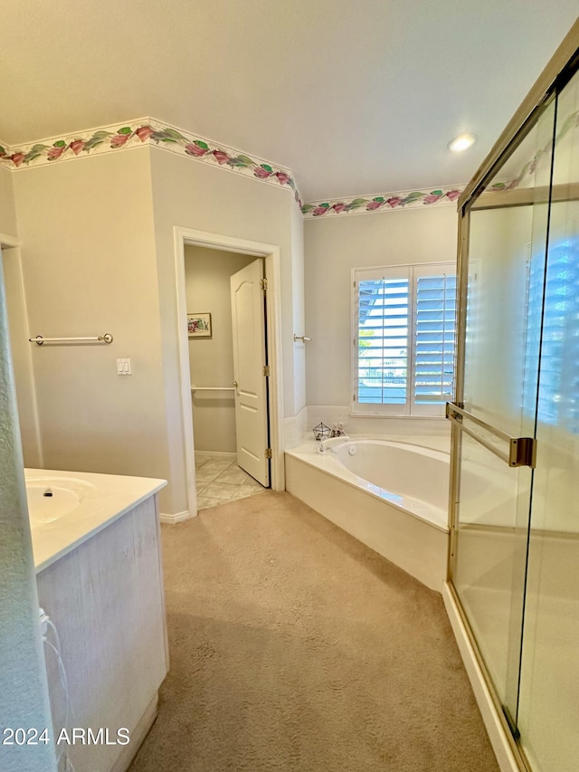 bathroom with vanity and separate shower and tub