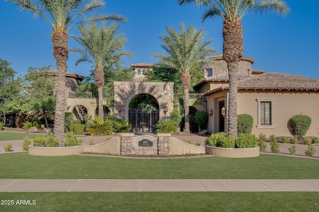 mediterranean / spanish-style home featuring a front yard