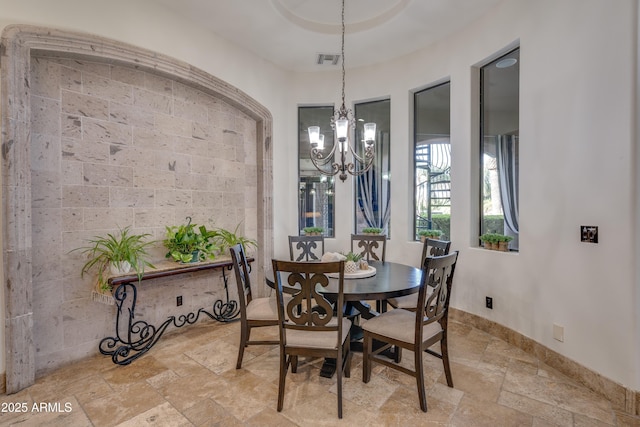 dining space with a notable chandelier