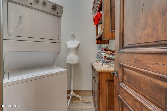 clothes washing area with stacked washer and clothes dryer