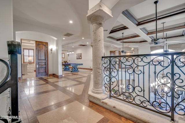 corridor with beam ceiling, coffered ceiling, and decorative columns