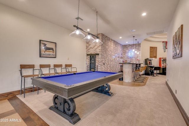 rec room featuring brick wall, pool table, and light hardwood / wood-style flooring