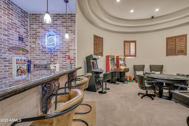 office space with light colored carpet, bar area, and a tray ceiling