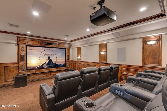 carpeted cinema room featuring ornamental molding