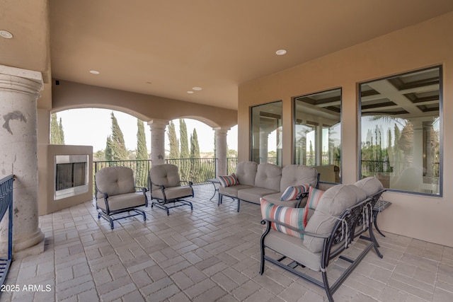 view of patio featuring an outdoor living space with a fireplace