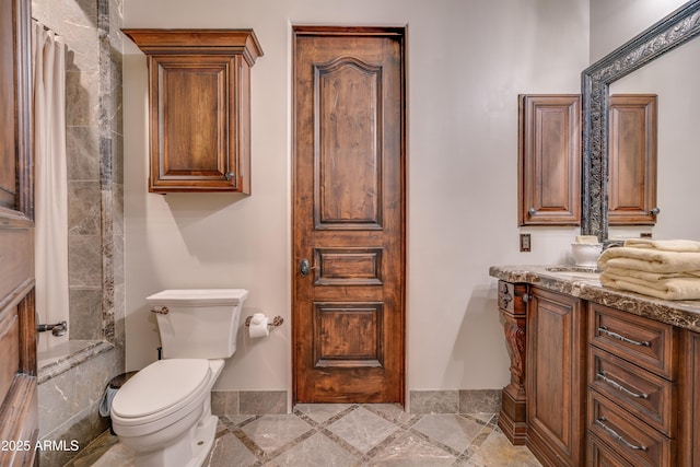 bathroom featuring toilet and vanity