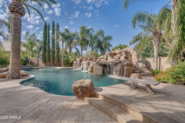 view of swimming pool with pool water feature