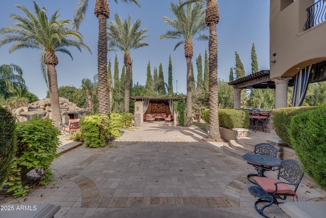 view of patio with exterior fireplace