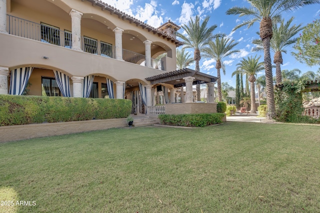 exterior space with a pergola and a yard