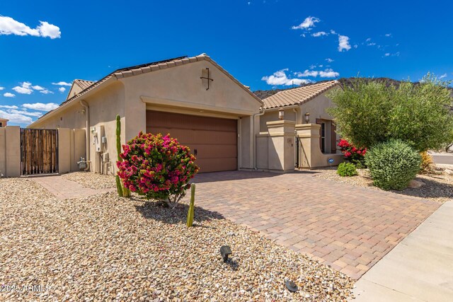 14552 S 182nd Dr, Goodyear, AZ 85338 - view of front of home featuring a garage, a gate, stucco siding, and decorative driveway