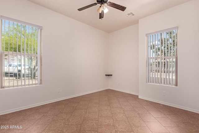 14552 S 182nd Dr, Goodyear, AZ 85338 - spare room featuring a ceiling fan, baseboards, visible vents, and a wealth of natural light