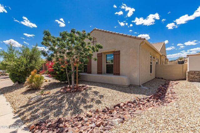 14552 S 182nd Dr, Goodyear, AZ 85338 - view of home's exterior featuring a tiled roof, fence, and stucco siding