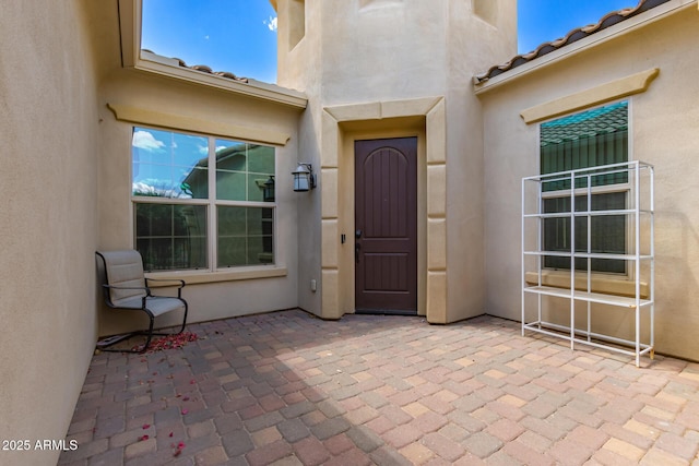 14552 S 182nd Dr, Goodyear, AZ 85338 - doorway to property with stucco siding, a patio area, and a tile roof