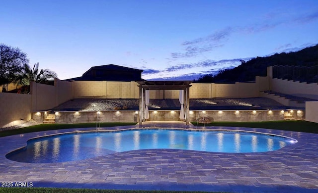 14552 S 182nd Dr, Goodyear, AZ 85338 - pool at dusk with a sink, a fenced backyard, and an outdoor pool