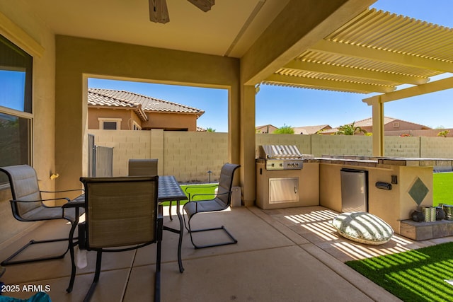 14552 S 182nd Dr, Goodyear, AZ 85338 - view of patio / terrace featuring fence, a pergola, an outdoor kitchen, grilling area, and outdoor dining area