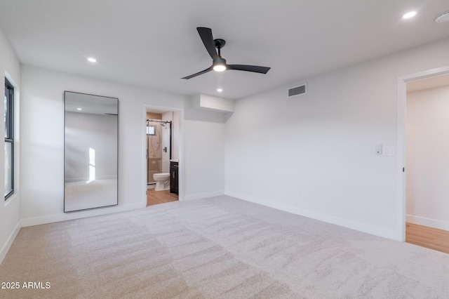 unfurnished bedroom featuring baseboards, ensuite bathroom, visible vents, and recessed lighting