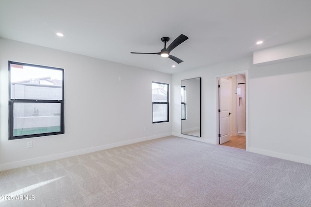 unfurnished bedroom with recessed lighting, baseboards, and light colored carpet