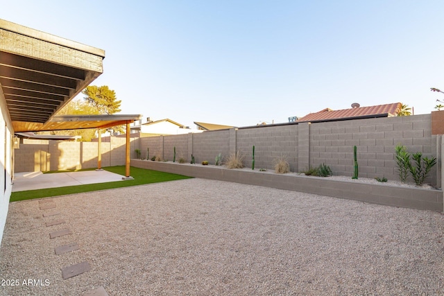 view of yard with a fenced backyard and a patio