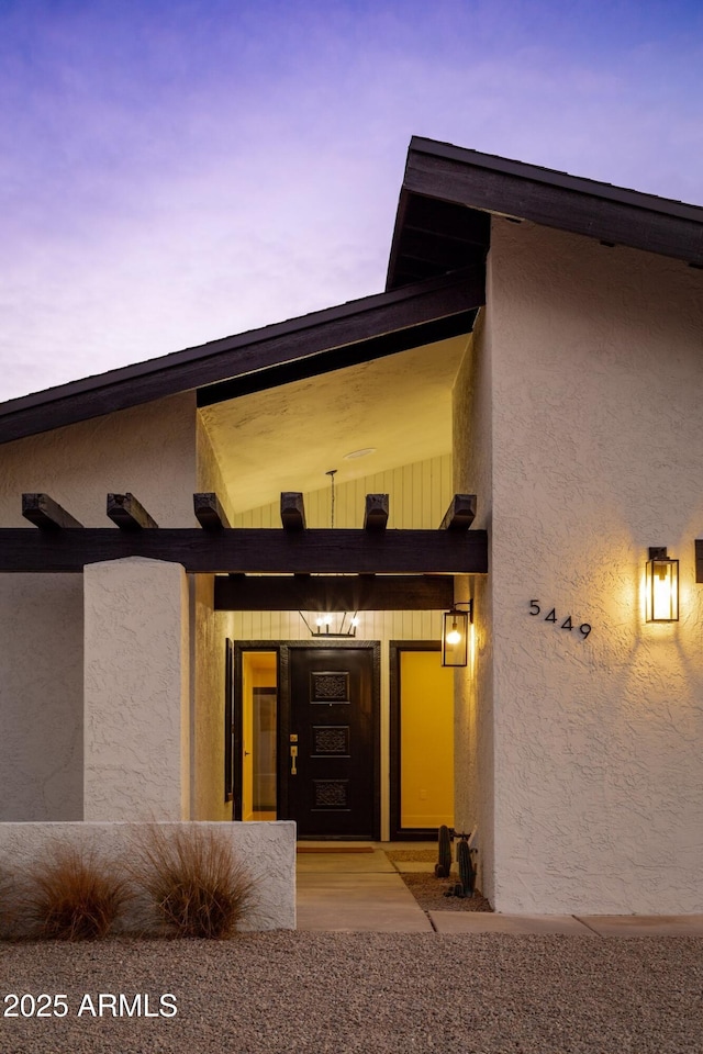 property entrance with stucco siding