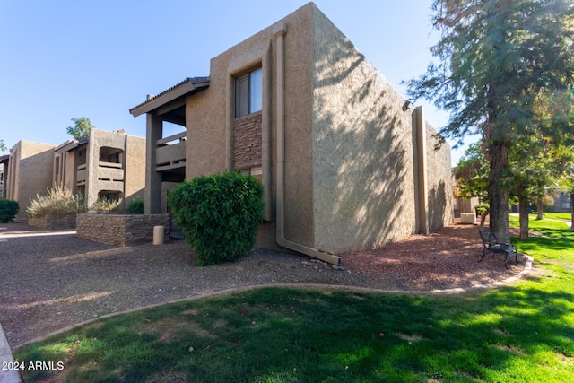 view of side of property with a balcony