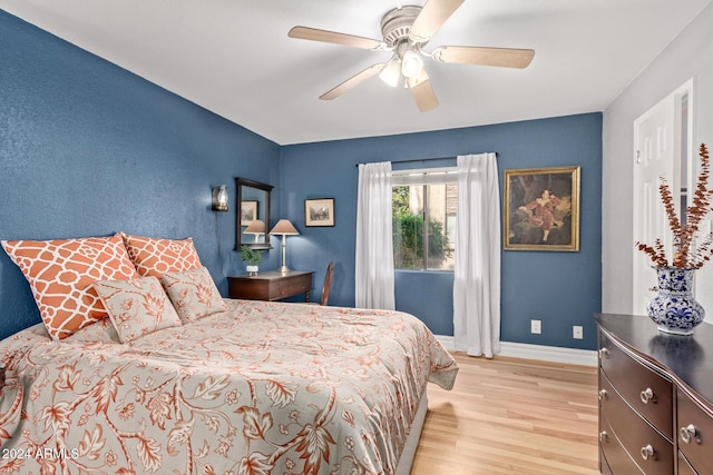 bedroom with light hardwood / wood-style flooring and ceiling fan