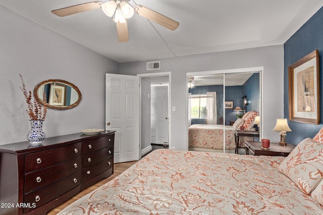 bedroom featuring ceiling fan, a closet, and light hardwood / wood-style flooring