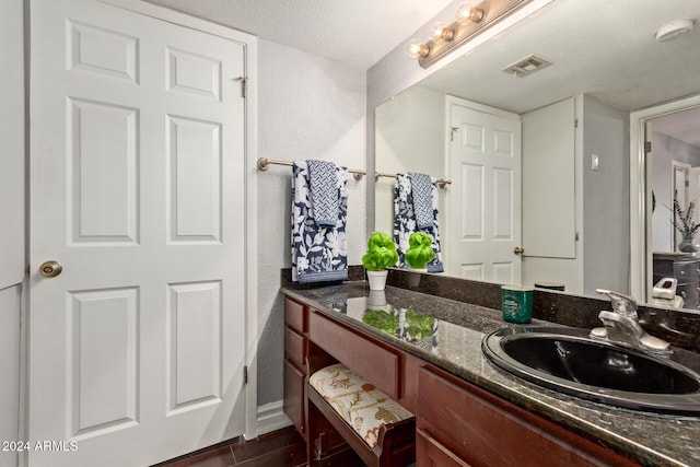 bathroom featuring vanity and a textured ceiling