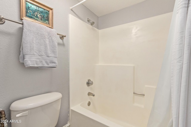 bathroom with toilet and shower / tub combo