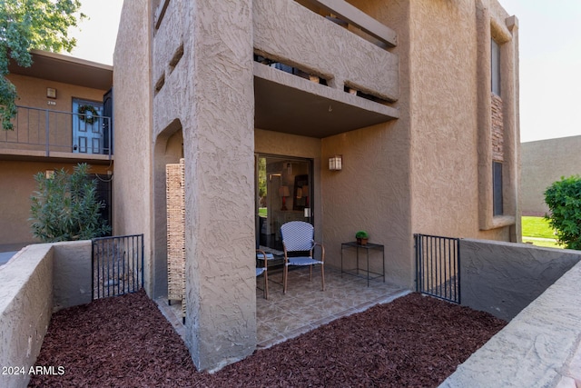 entrance to property with a patio area