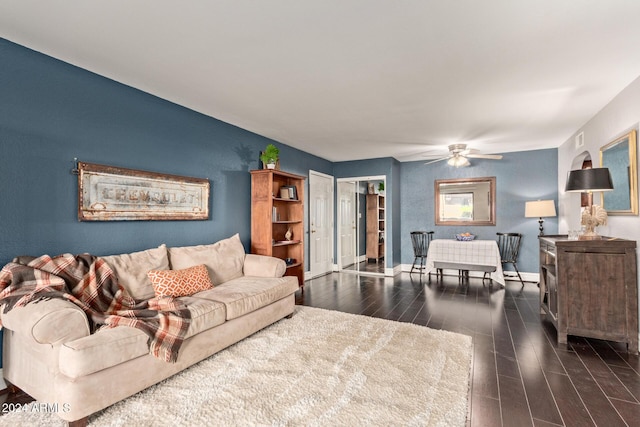 living room with dark hardwood / wood-style flooring and ceiling fan